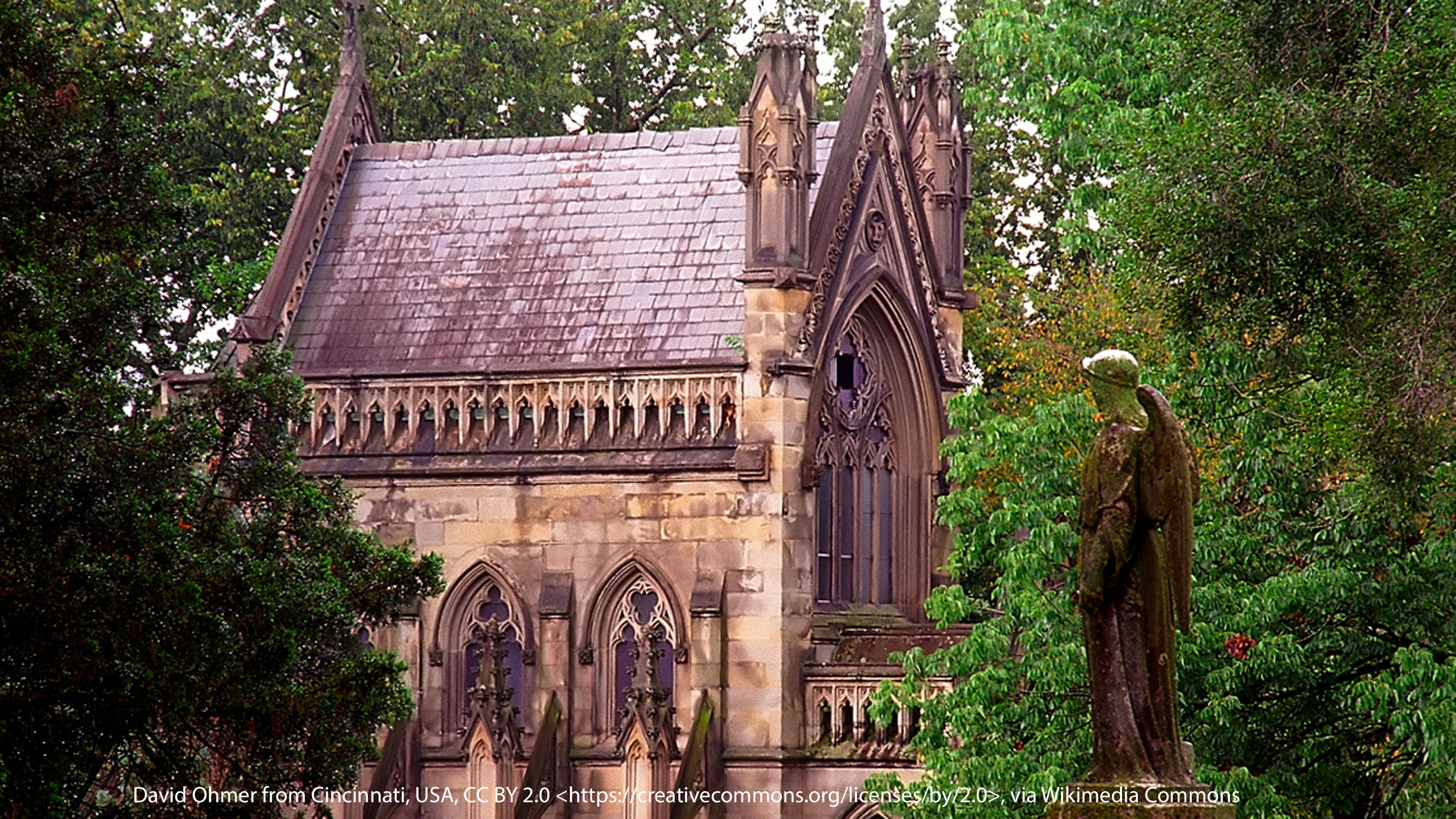 Photograph of the angel statue at the Dexter Mausoleum in Spring Grove Cemetery, highlighting its detailed sculpture and serene setting